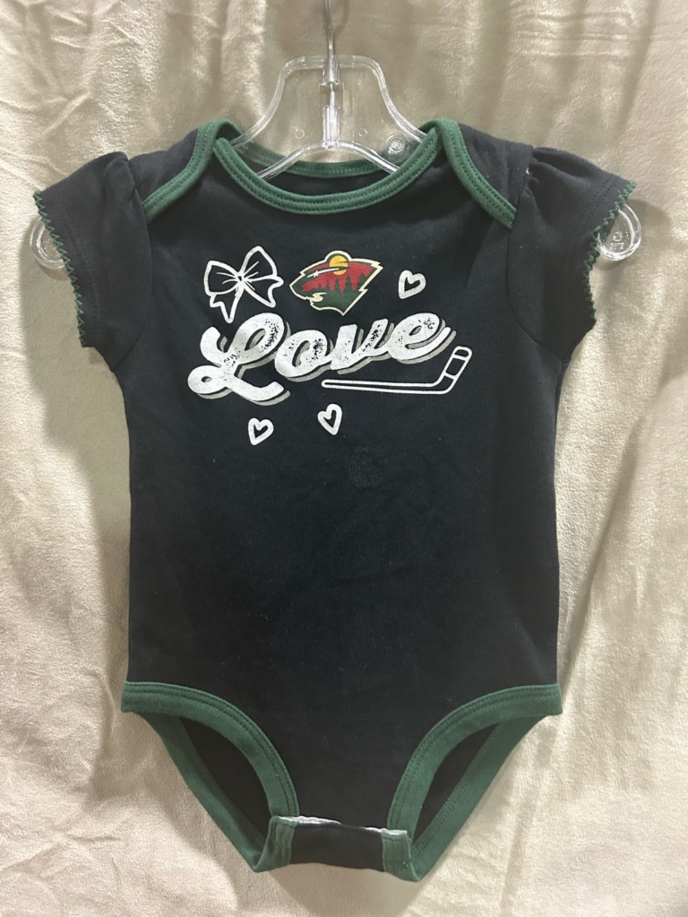 NHL Black Onesie with Green Ribbed Collar and Team Graphic